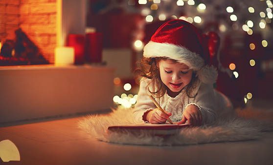 Christmas Wishing Tree - Girl with Santa Hat making a list